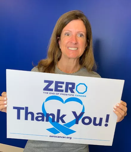 ZERO Board Member Sandy Maxey holding a thank you sign