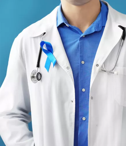 A doctor wearing a blue ribbon