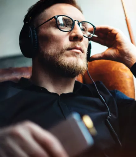 Man sitting in chair with headphones on