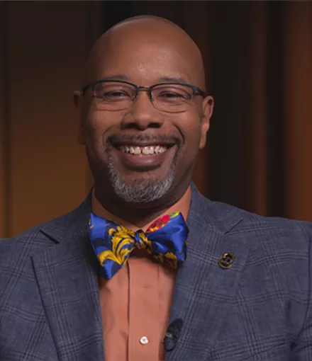 Dr. Kelvin Moses smiling with a big bow tie