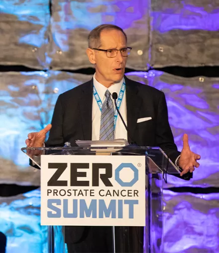 Tom Bognanno standing at the podium at the 2023 Summit