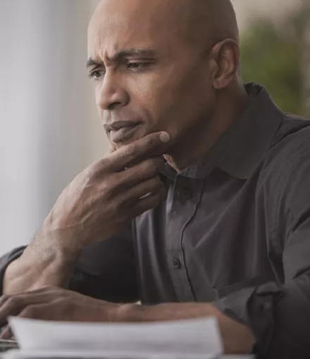 Middle aged black man looking at laptop