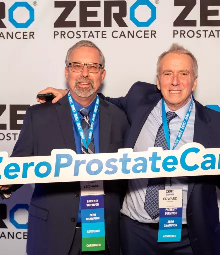 Two middle-aged white men holding a ZERO Prostate Cancer sign