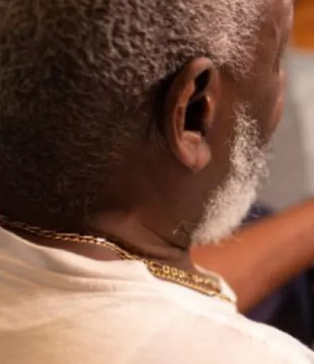 Man Looking at his laptop while sitting and reading about prostate news