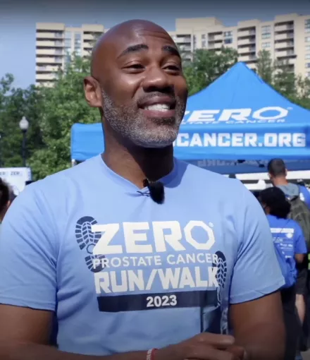 A black man wearing a 2023 ZERO Run/Walk shirt talking to the camera