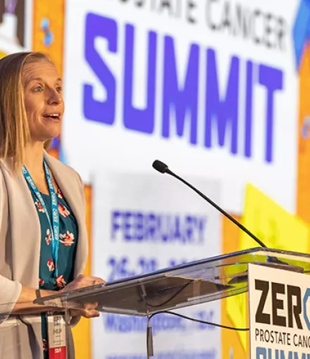 A blonde woman, Shelby Moneer, standing at a podium during the ZERO Summit 2023