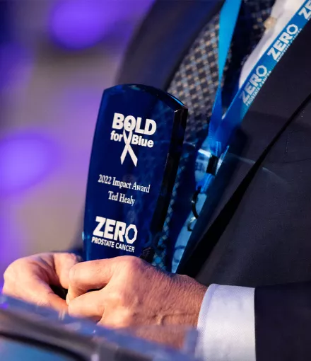 A shot of someone's hands at the podium holding a Bold for Blue award