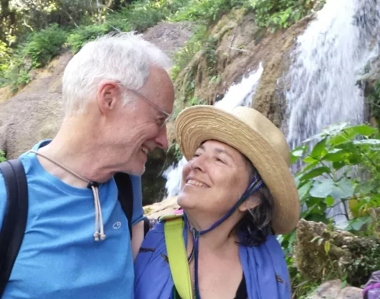 James and wife at waterfalls staring happily at each other