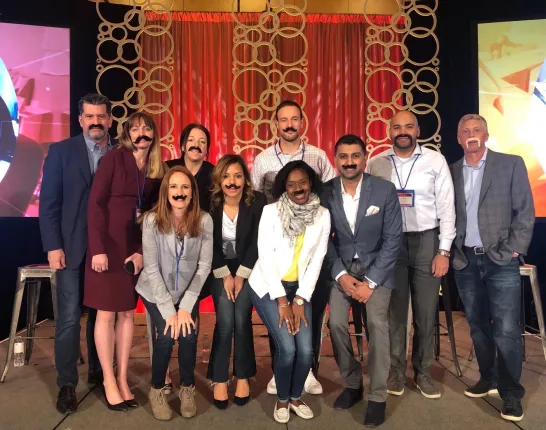 Business professionals wearing goofy fake moustaches