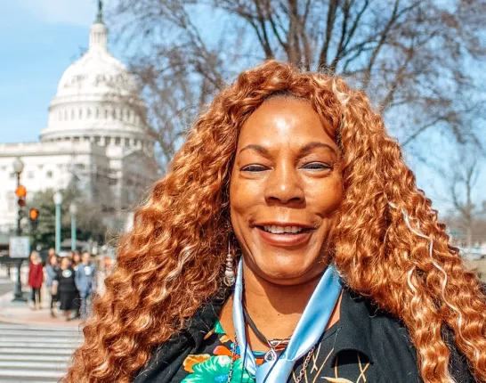 African American woman with long hair in front of the Capitol