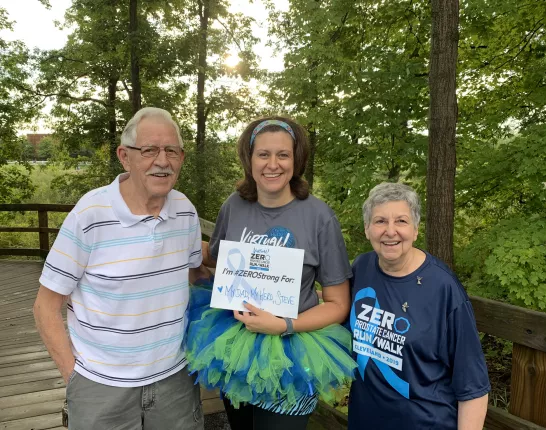 Stephanie Mueller sporting a tutu next to her parents at a charity run/walk event