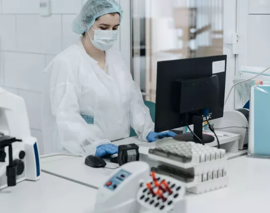 Woman Working in a Laboratory Wearing a Personal Protective Equipment