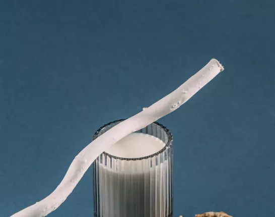 Straw on Top of Glass of Milk with walnuts