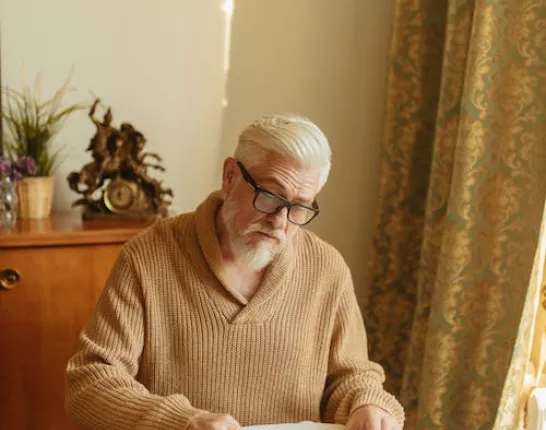 Man in Brown Knitted Sweater Organizing the Medicines