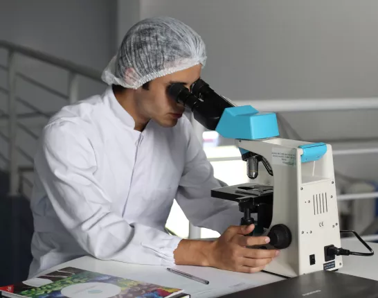 A man looking through a microscope