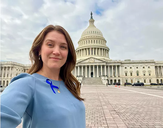 ZERO Champion wearing blue ribbon outside of the Capitol building