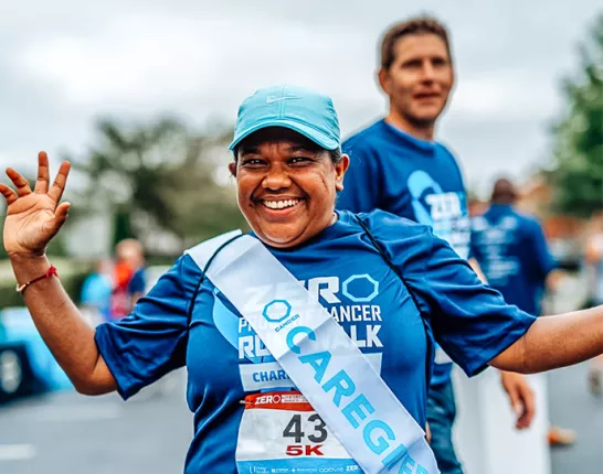 Woman wearing a caregiver sash at a Run/Walk event