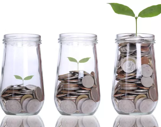 Three glass jars with metal coins in them