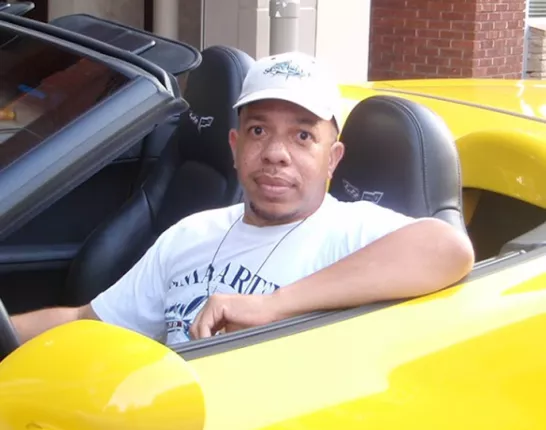 Jeff Fortson in a yellow convertible 