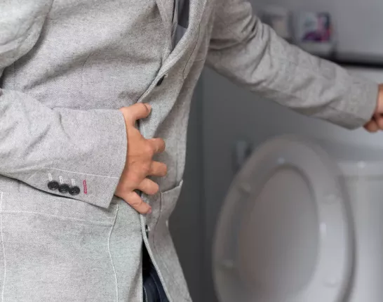 Men in a grey suit in a toilet