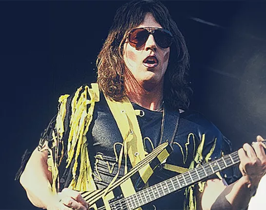 Young Jay Jay French playing guitar at a concert 
