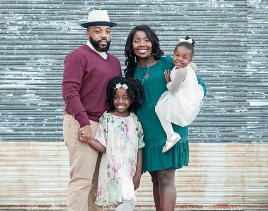 Prostate cancer survivor, Mical Roy, his wife, and two daughters