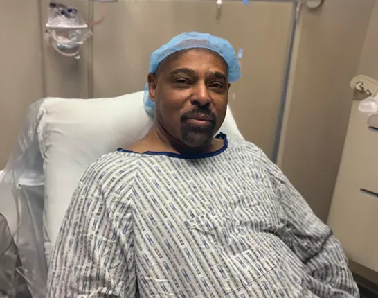 Dennis Stanley in a hospital bed