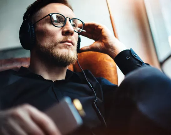 Man sitting in chair with headphones on