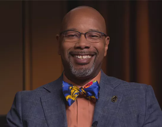 Dr. Kelvin Moses smiling with a big bow tie