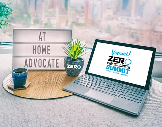 Laptop with sign next to it that says "At Home Advocate"