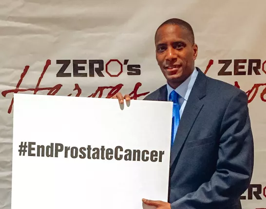 African American men holding a sign "End Prostate Cancer"