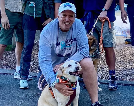 Champion Ted Healy crouched down by his dog
