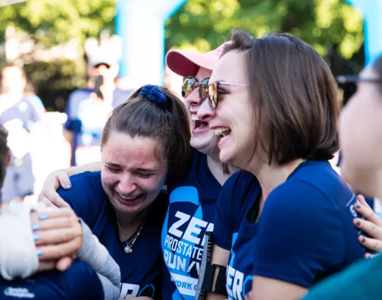 Three women hugging each other and crying
