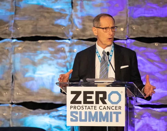 Tom Bognanno standing at the podium at the 2023 Summit