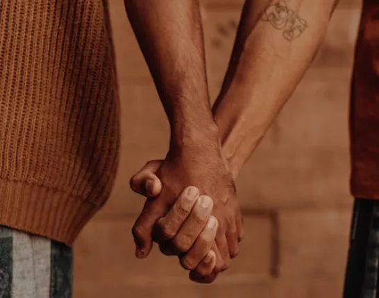 Two men holding hands
