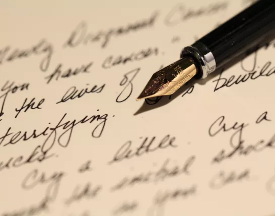 A hand-written letter and ink pen