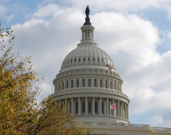 The dome of the Capitol against a sky with clouds