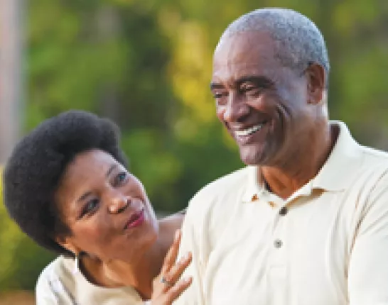 A man and woman enjoy their walk together outside.