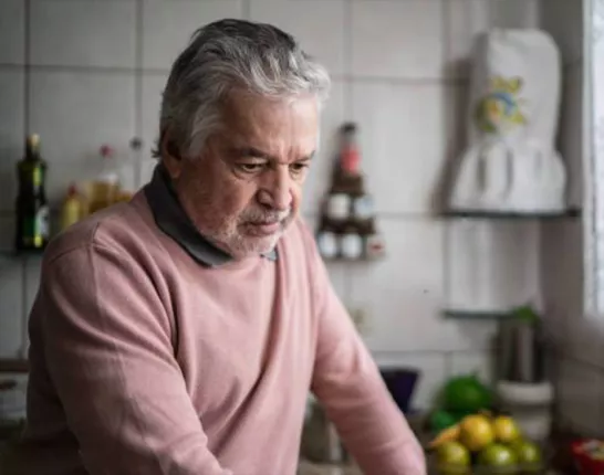 Distressed Hispanic man in a kitchen