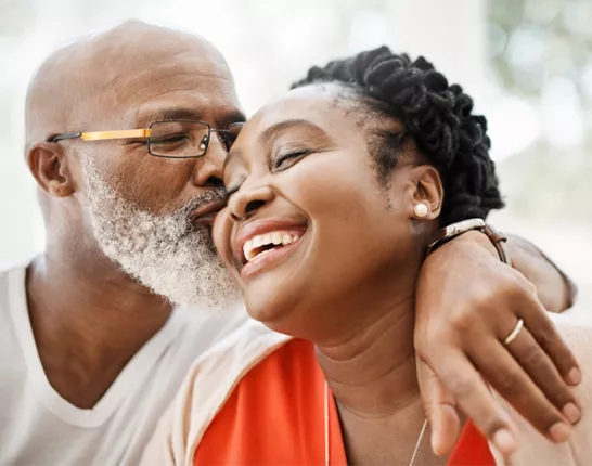 Old man giving a woman a kiss on the cheek