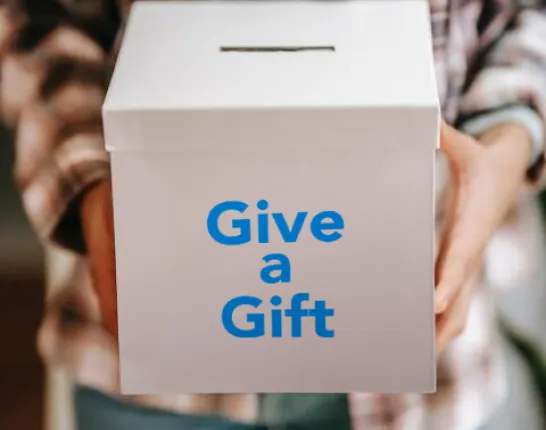 Man holding box that says 'Give a Gift'