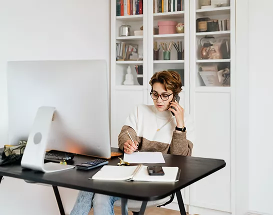 Woman on phone in home office