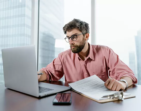 man looking at computer in office