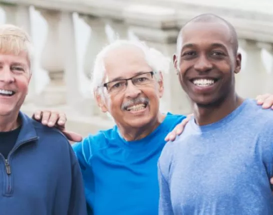 Group of men smiling wearing blue