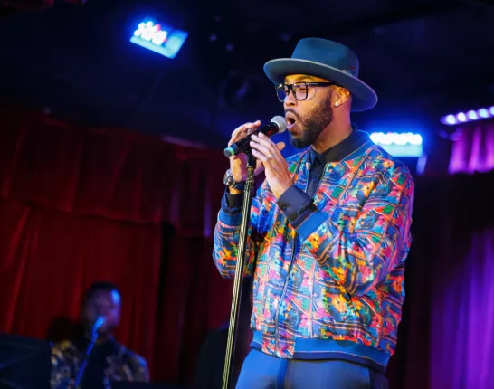 Montell Jordan Performing with Blue Hat and Glasses