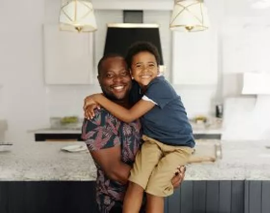 father_and_son_hugging_kitchen_banner