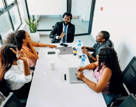 Man sitting at conference table with other colleagues