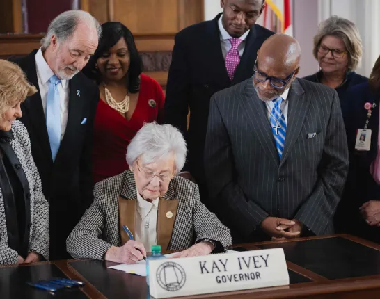 Picture of Alabama representatives signing documents 
