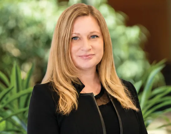 Headshot of Colleen Wood in front of plant