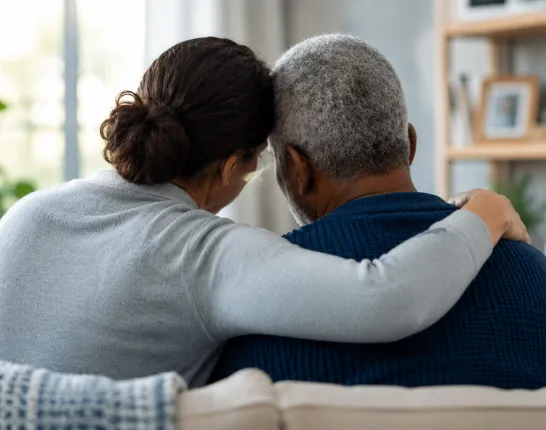 Illustration representing a caregiver providing comfort and emotional support to a loved one affected by prostate cancer.